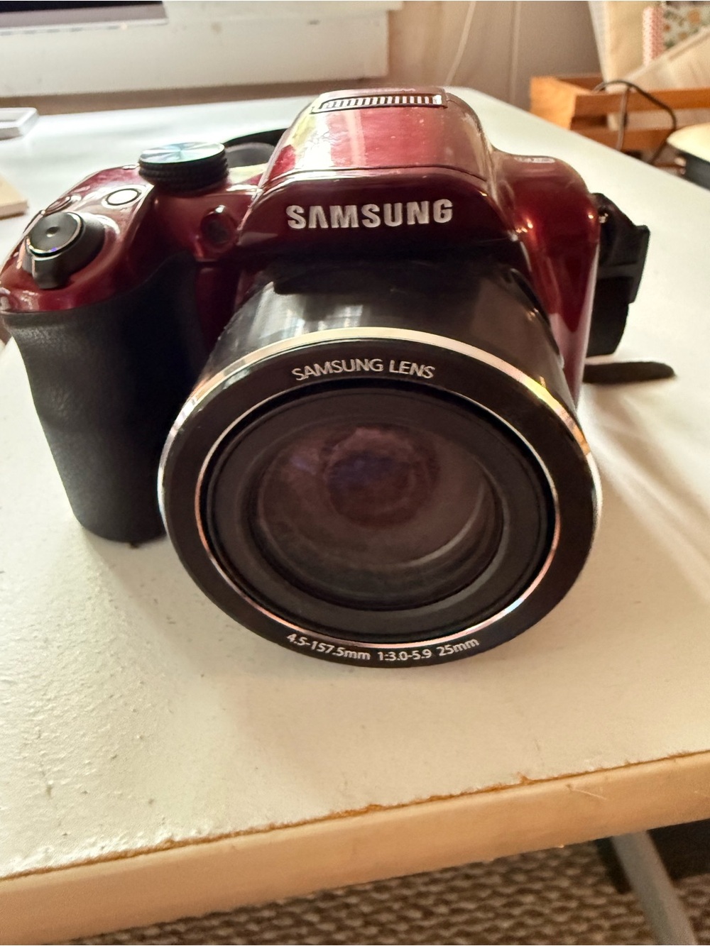 Samsung glossy red digital bridge camera with Samsung lens